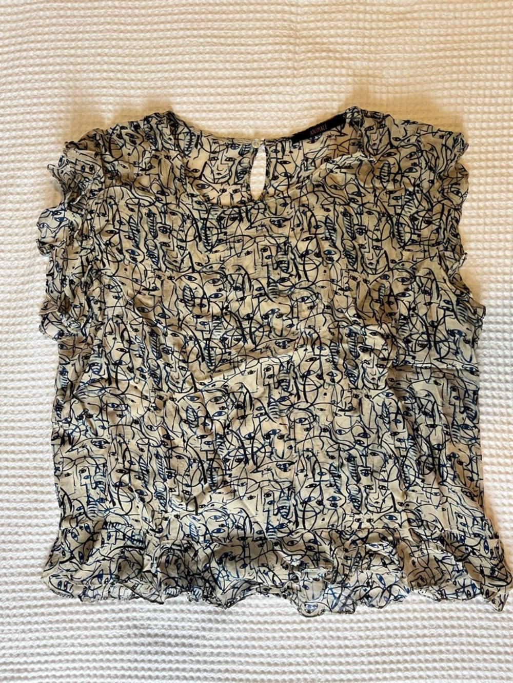 Animale Cream Top with Black Abstract Face Print and Ruffle Sleeves